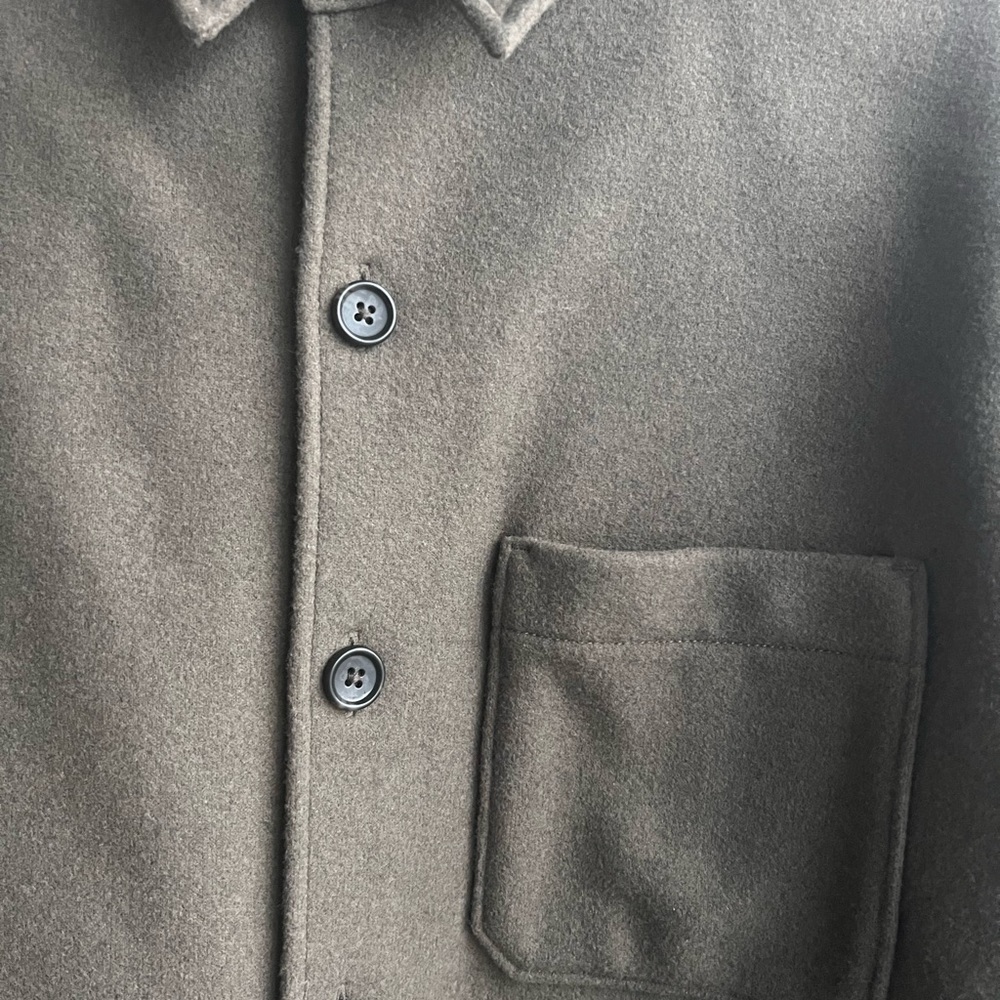 Shirt  jacket with a curved hem and stand collar.